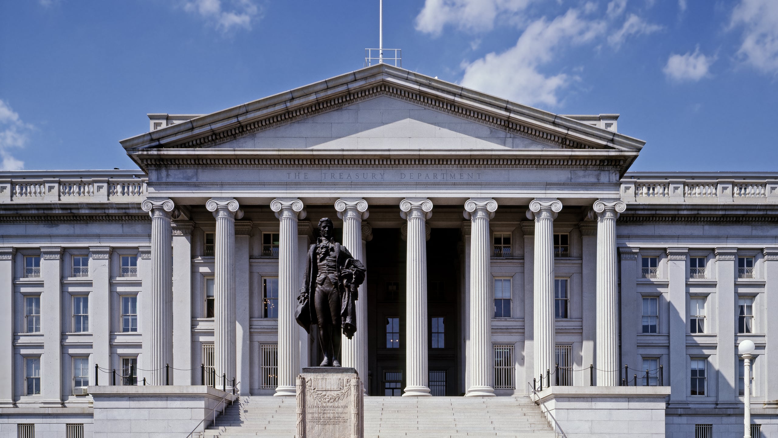 The U.S. Treasury Building in Washington, D.C., with the statue of Alexander Hamilton in front of its columned portico